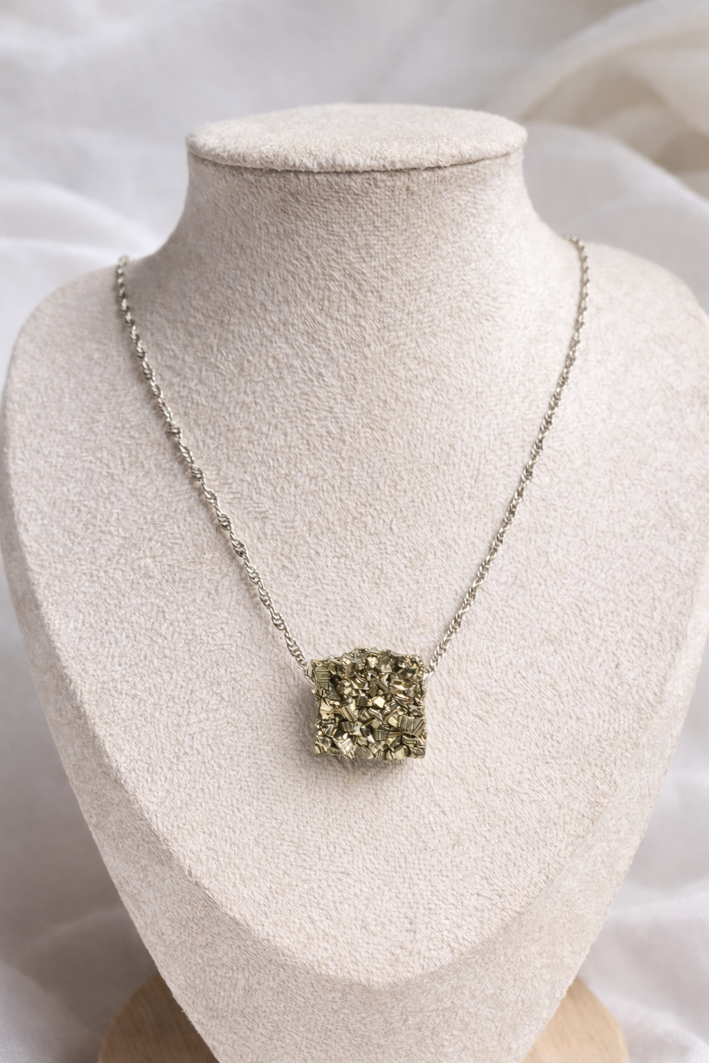 Pyrite crystal necklace worn on sterling silver chain