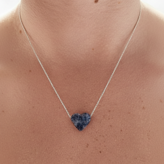 Heart-shaped sodalite crystal necklace on delicate sterling silver chain worn on the neck