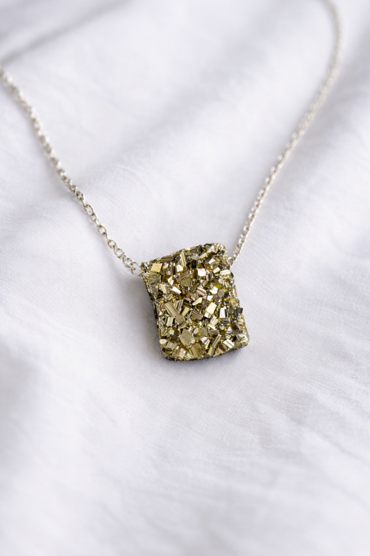 Pyrite crystal necklace worn on sterling silver chain